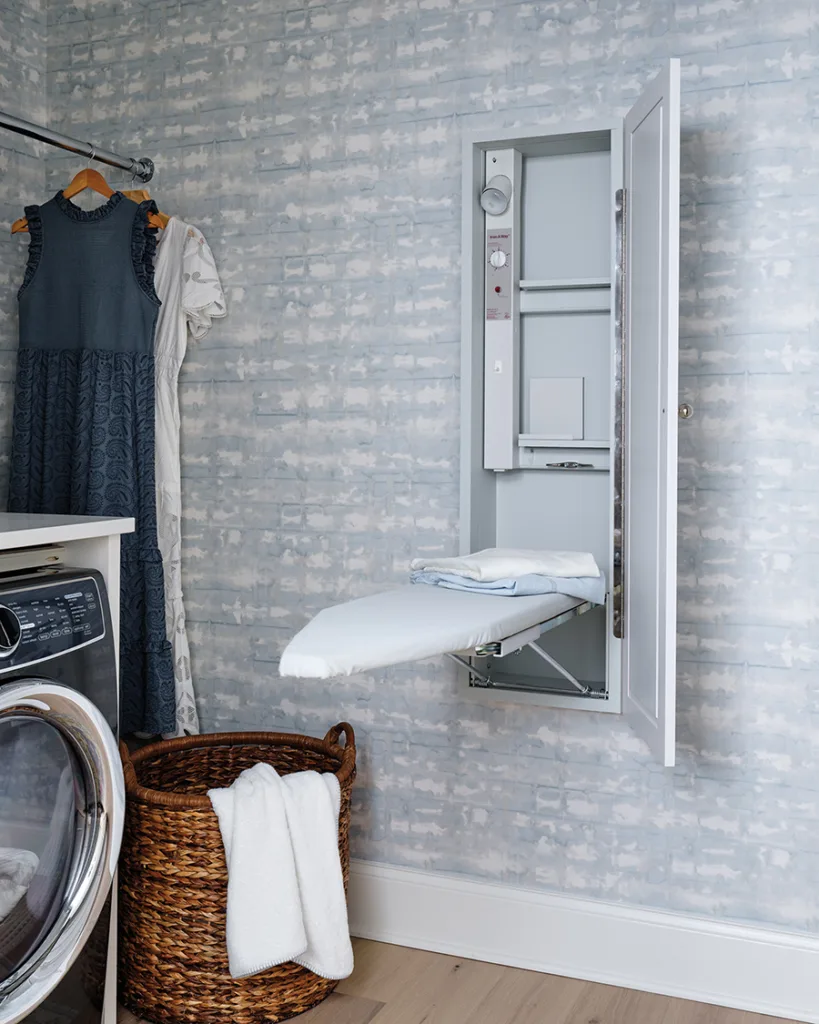 Wall mounted ironing board in laundry room.