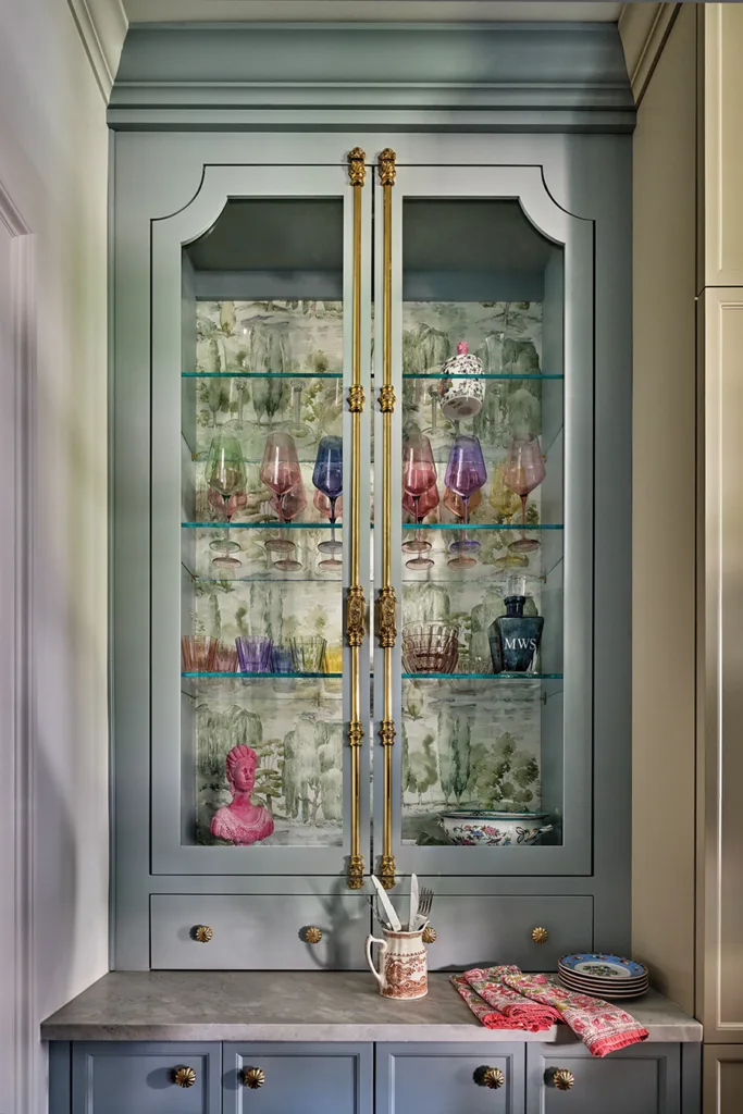 Jewel box: A pair of built-in china cabinets serves as a butlery housing pretty glassware and decorative items.