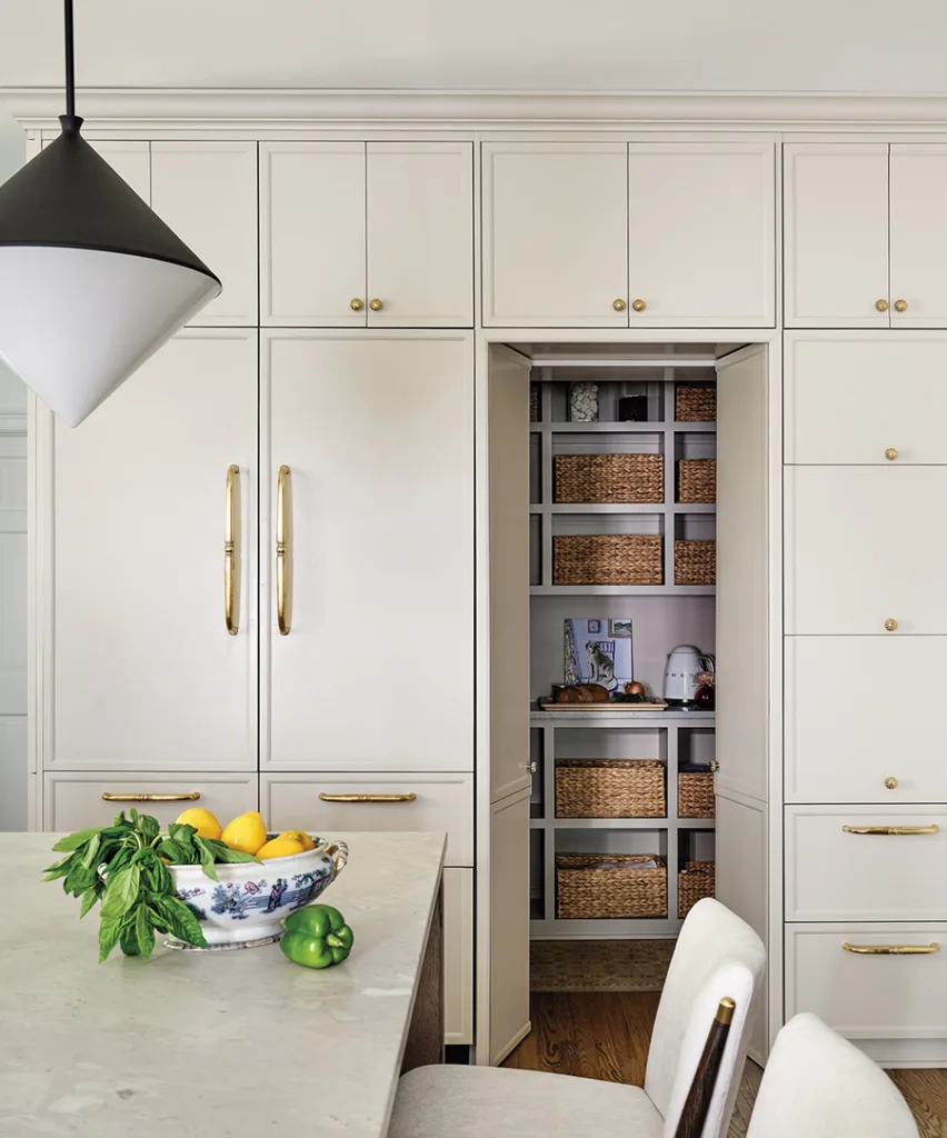 With two young kids, managing clutter was a must for this busy family. Paneled doors conceal a pantry with streamlined storage by Simplicity Organizers.