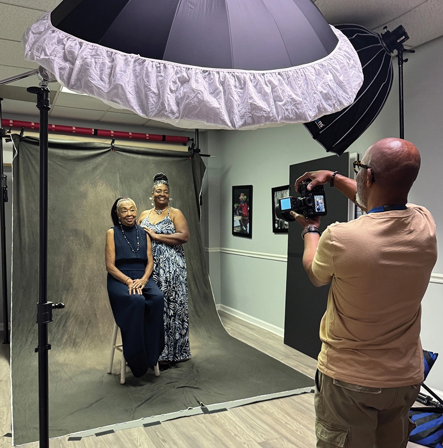 Adriane Muhammad and her mother, Mae Anderson, sit for a photo during a portrait day featuring mothers and daughters from the Frankie Mae Foundation, a separate nonprofit focused on supporting caregivers.