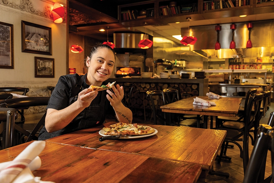 Chef Brittany Cochran eating pizza